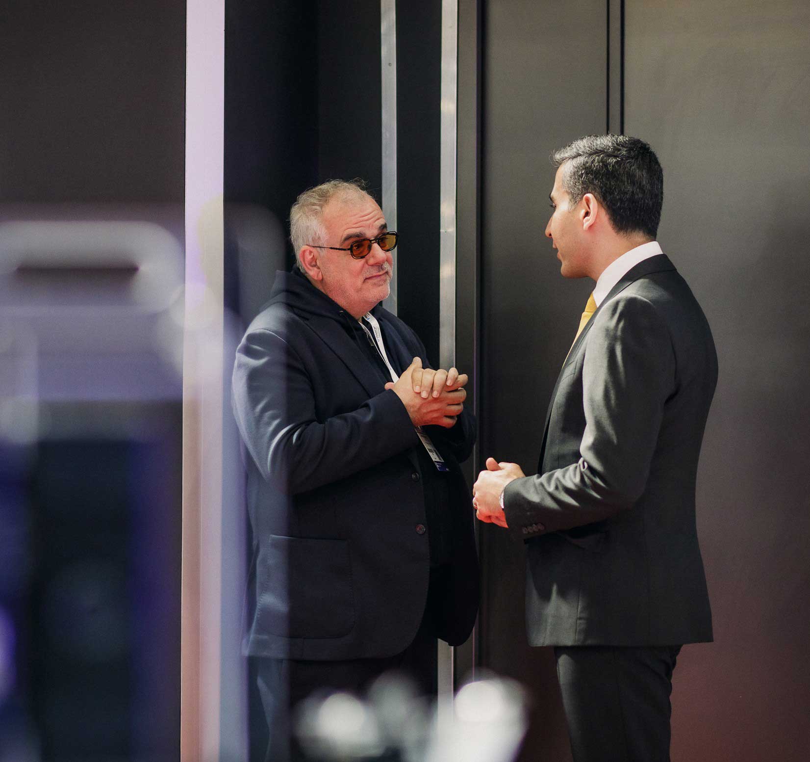 Ali Aydan speaking with a guest during a professional discussion at a DORIX corporate event.